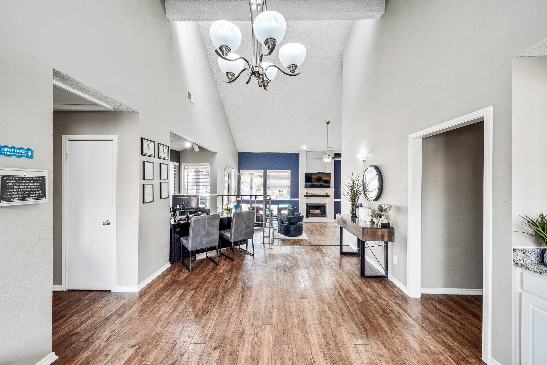 a living room and dining room with a table and chairs and a chandelier